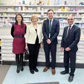 Leyla Hannbeck visiting a pharmacy in a group press photo