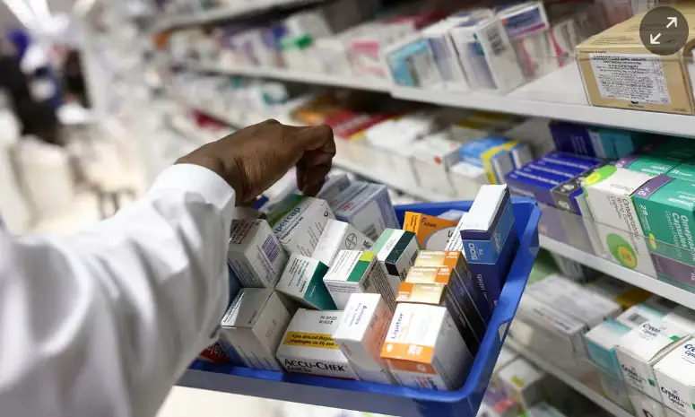 Pharmacist stocking shelves