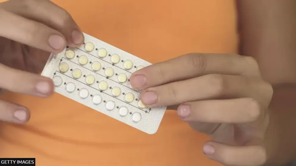 A person taking a tablet from a blister pack