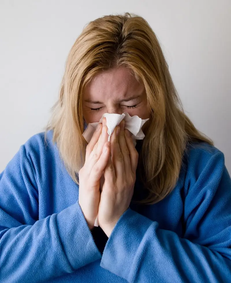 Women in a blue towelling robe with a cold infection