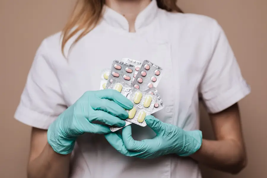 Pharmacist holding several blister packs