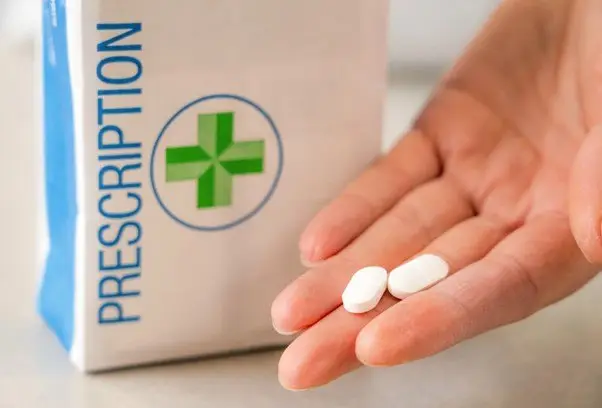 Prescription bag with a hand with two pills held