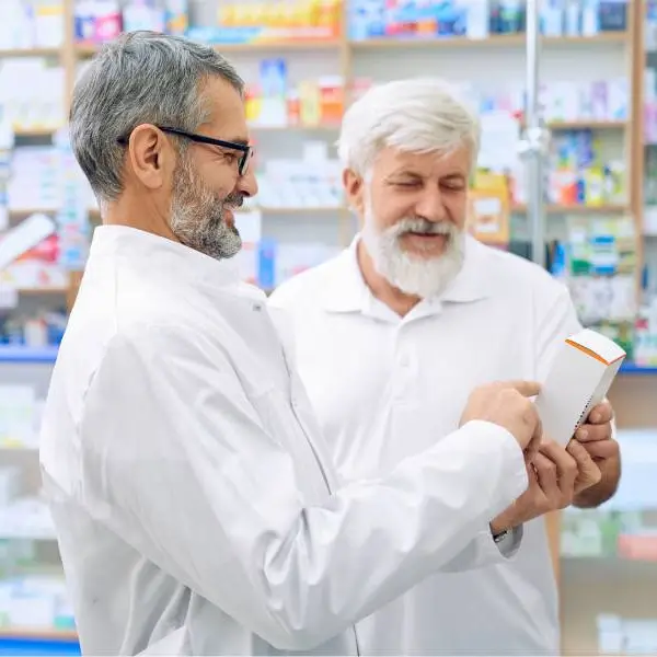 Two elderly male pharmacists comparing notes